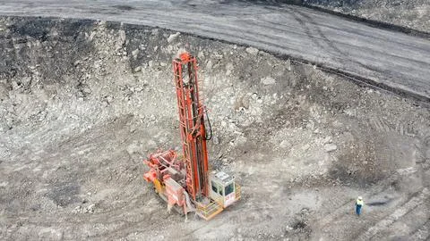Large open-pit coal mine operation with heavy machinery and drilling equipment Foto stock