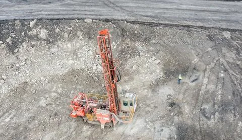 Large open-pit coal mine operation with heavy machinery and drilling equipment Stock Photos