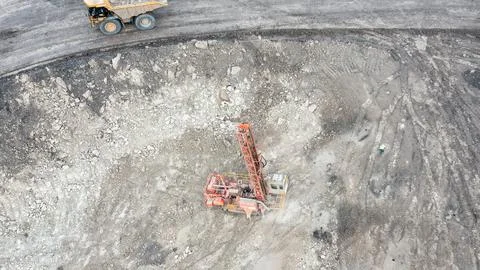 Large open-pit coal mine operation with heavy machinery and drilling equipment Stock Photos