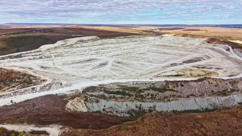 Large open pit mine shows extensive land use for mining activities in a remote Stock Footage 345457878