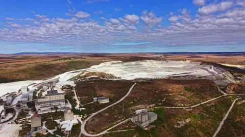 Large open pit mining site shows vast landscape and industrial structures in Stock Footage 345455164