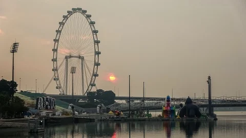 Large Orange Ball Of Sun Rises Behind The Singapore Flyer Stock-Footage 97185840
