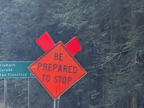 Large orange “Be Prepared to Stop” construction warning sign stands before Stock Photos
