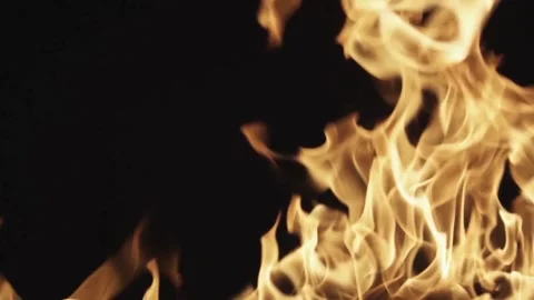 Large orange fire flames burning against a black background Stock Footage 329734499