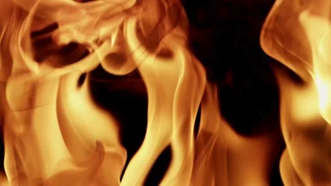 Large orange fire flames dancing on a black background Stock Footage 329733907