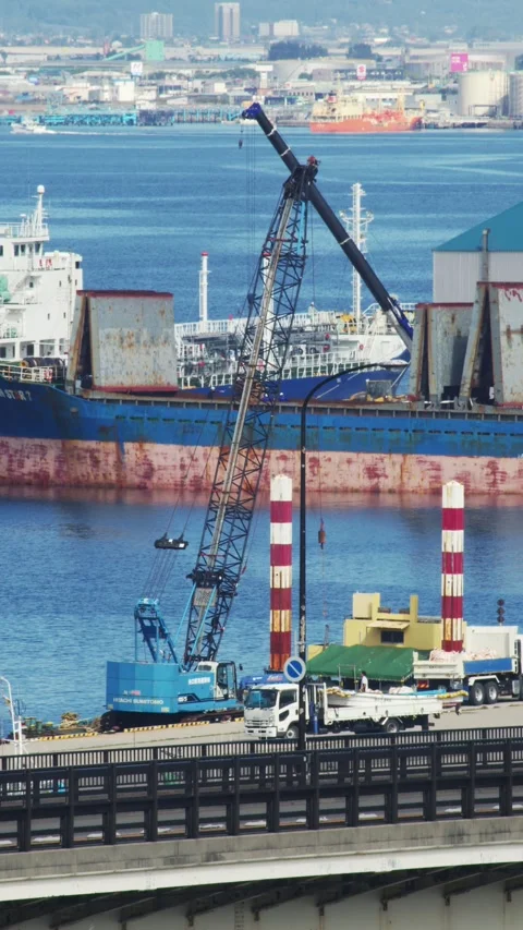 Large orange floating crane and tugboats in a port, Hakodate, Japan, 2026.09.10. 動画素材 345440927