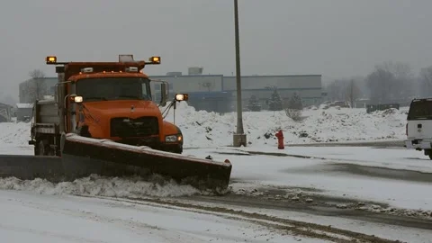 Large Orange Snow Plow Pushing Snow, Left to Right, Winter, Blizzard Stock Footage 148704010