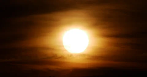 Large Orange Sun Behind Thin Layer of Clouds at Sunset 10bit, 4K Stock Footage 65890426