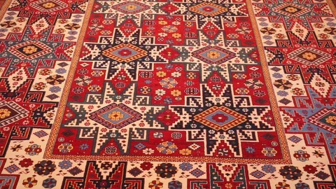 Large oriental carpet with colorful patterns. Handmade carpet production Stock Footage 120314065