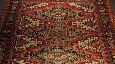 Large oriental carpet with colorful patterns. Handmade carpet production Stock Footage 120314119