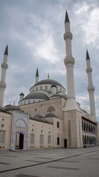 Large Ottoman style mosque complex with spacious courtyard and tall minaret.. Stock Photos