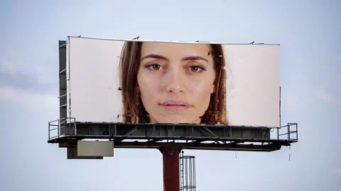 Large outdoor advertising board with digitial female face video Stock Footage 312707730