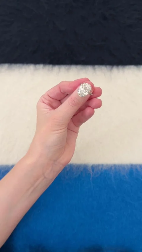 Large oval diamond engagement ring against blue textured background Stock Footage 328251273