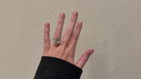 Large oval diamond solitaire engagement ring sparkling on hand Stock Footage 325876855