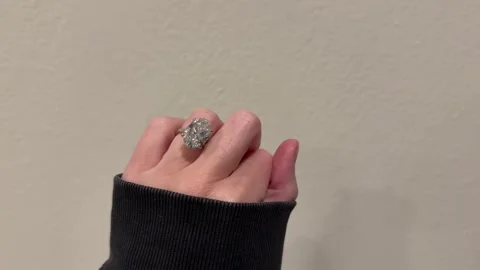 Large oval diamond solitaire engagement ring sparkling on hand Video stock 325876987