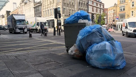 https://images.pond5.com/large-overflowing-wheeled-trash-can-footage-125695032_iconl.jpeg