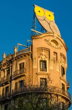 A large owl on a top of a building in Barcelona, Spain Stock Photos