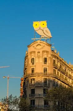 A large owl on a top of a building in Barcelona, Spain Stock Photos