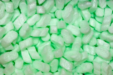 Large packaging box filled with many white styrofoam pellets, close up shoot Stock Photos