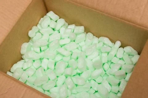 Large packaging box filled with many white styrofoam pellets Stock Photos