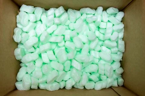 Large packaging box filled with many white styrofoam pellets Stock Photos