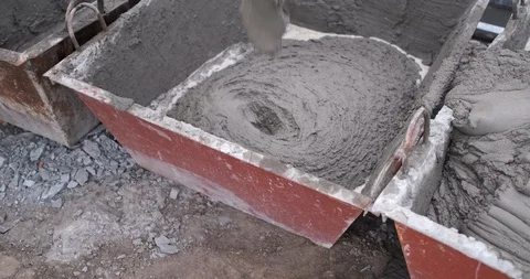 Large pallet is quickly filled with mortar, next to it second one already full Stock Footage 117062826