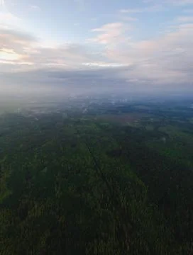 Large panorama of clouds over forests, fields and villages in Russia from the Stock Photos