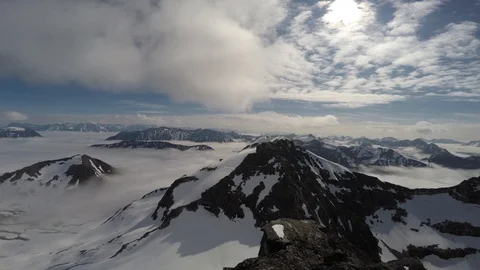 Large panoramic shot of high Norwegian mountains getting out the clouds, Tromso Stock Footage 102153694