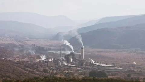 Large paper mill in the Elands valley South Africa with smoke coming from its Stock Footage 84201580