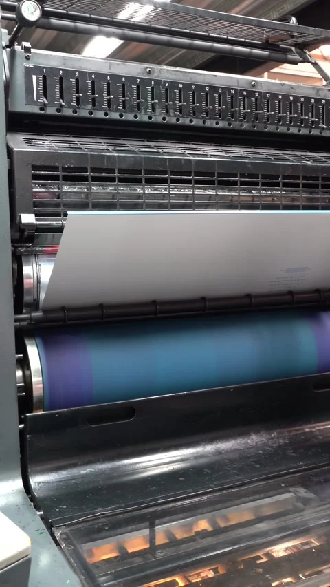Large paper sheet entering rollers in industrial printing machine Stock Footage 326452560