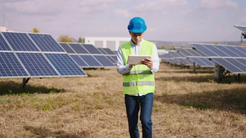 Large park of solar panels battery walking in front of the camera young asian Stock Footage 163970542