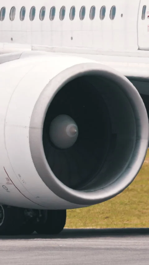 Large passenger airplane engine during taxiing on runway Stock Footage 327637990