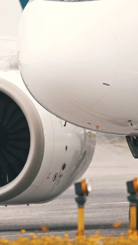 Large passenger airplane engine taxing on runway Stock Footage 327637082
