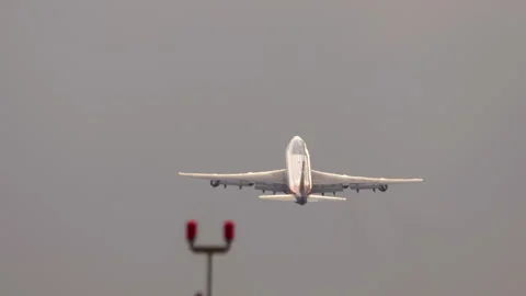 Large passenger airplane taking off and climbing into cloudy sky Stock Footage 340106394