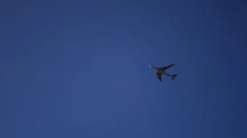 A large passenger plane flew over the blue clear sky. 4k, 3840x2160 Stock Footage 74669539