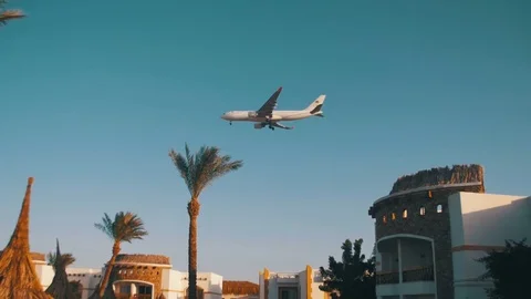 Large Passenger Plane Flying in the Sky over Hotels in Egypt Stock Footage 73201869