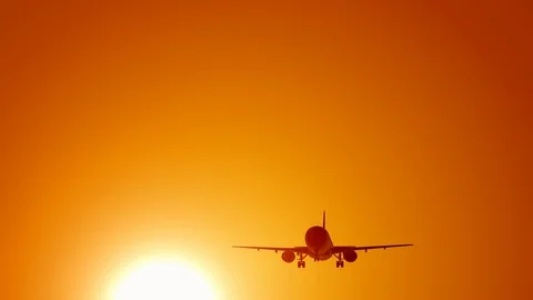 A large passenger plane takes off against the background of a sunset. Orange Stock Footage 123299516