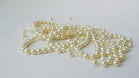 Large Pearl Beads Roll Down One After another. Pearl necklace Close up Stock Footage 123073669
