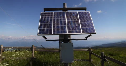 Large photovoltaic solar panel producing electric energy near tower blue sky Stock Footage 157364802