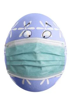 Large picture of an isolated easter egg with floral pattern, eyes and mask. 库存照片