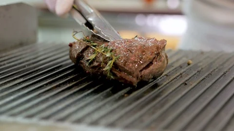 Large piece of beef meat prepared on a grill pan Stock Footage 106186838