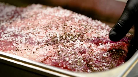 A large piece of beef is prepared by a chef for roasting Stock Footage 264310829