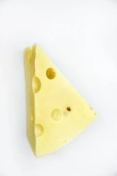 A large piece of cheese on a white background. A triangular piece of cheese.. Stock Photos