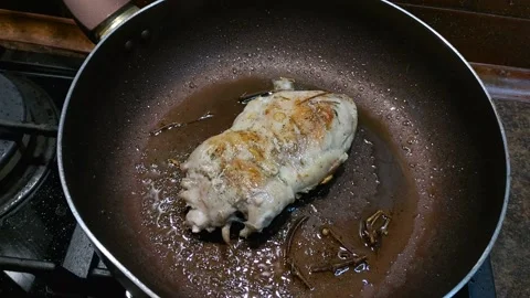 A large piece of chicken meat is fried in a pan Stock Footage 160627684