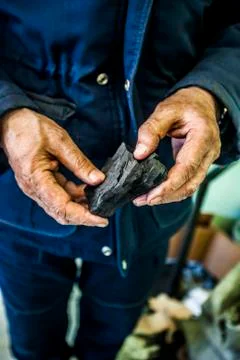 Large piece of coal in hands Stock Photos