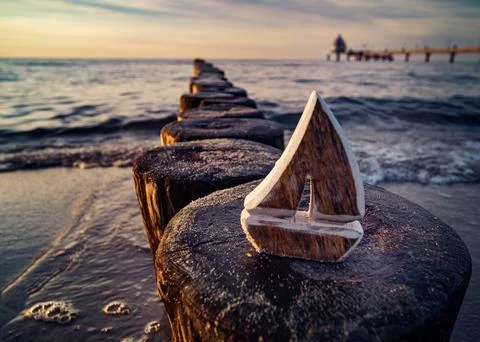 A large piece of drift with a triangle on it in front of the ocean 写真素材