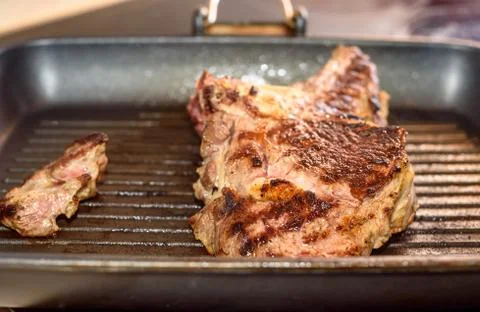 Large piece of fresh beef meat steak prepared on a grill pan. 写真素材