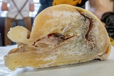 A large piece of hard cheese aged for over 3 years on the counter of the farm Stock Photos