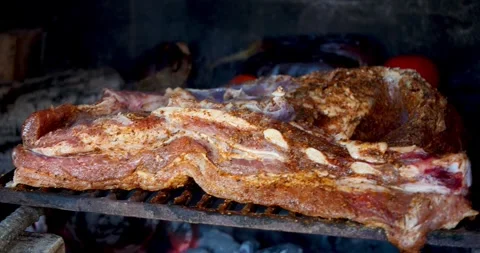 Large Piece Of Pork Ribs Is Grilling Over An Open BBQ Fire While A Hand Bas.. Stock Footage 346152123