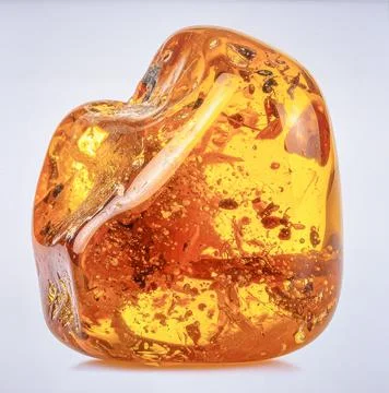 A large piece of raw amber with visible insect inclusion and honey color, i.. Stock Photos